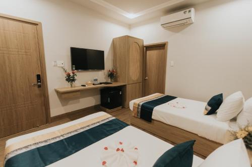 Postel nebo postele na pokoji v ubytování Khoa Hotel Phan Thiết