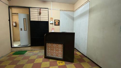 a room with a hallway with a door and a room with a fireplace at Hotel Shree Prabhu in Vovale