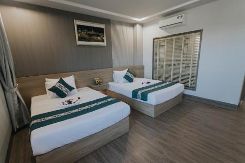 Postel nebo postele na pokoji v ubytování Khoa Hotel Phan Thiết