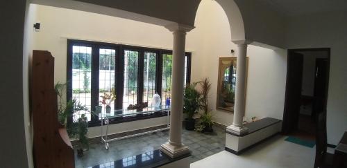 a hallway with a large window with plants in it at Shiraz villa in Chennai