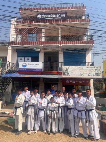 a group of people standing in front of a building at Hotel Atithi Devo Bhava in Lālbhitti