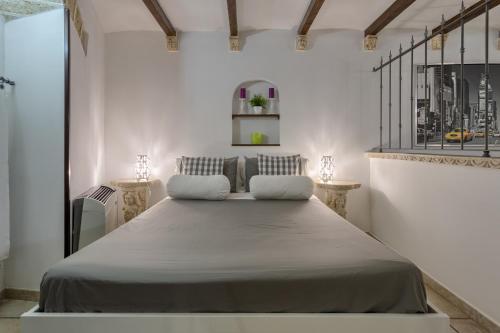 a bedroom with a large bed with two pillows at Due Passi Dal Borgo Antico in Bari