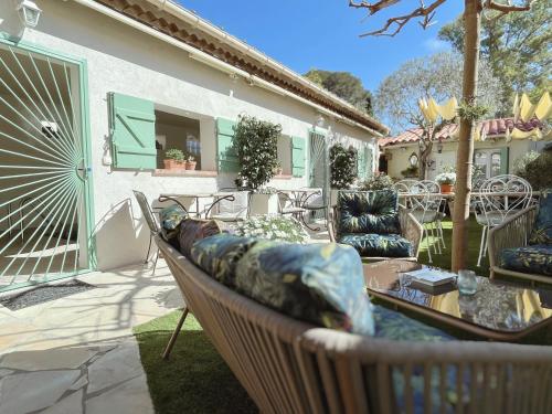 a patio with chairs and a couch on a patio at La Jabotte in Antibes