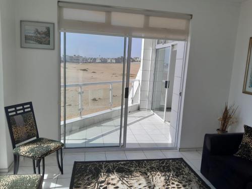 a living room with a view of the beach at Camere da Letto ON-THE-BEACH Self Catering in Swakopmund