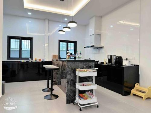 a kitchen with a counter and a island in it at Royal Palace Homestay in Taiping