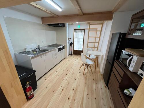 a small kitchen with a sink and a table at Only one group stays per day -Kanouya-家族や仲間と貸し切り宿 加納屋 in Nakatsugawa