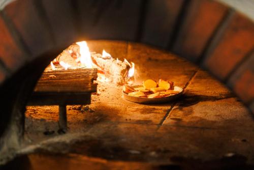 a fire oven with a bowl of fruit in it at Karja Accommodation in Haapsalu