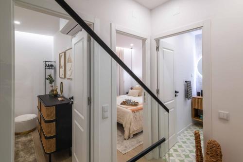 a hallway with a staircase leading to a bedroom at Beach Townhouse - Luxury, Wi-Fi, AC, 2 mins from the beach in Armação de Pêra