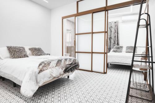 a bedroom with a large bed and a ladder at El Desembarco in Villajoyosa