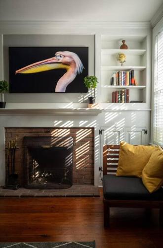a living room with a fireplace with a picture of a flamingo at Society Hill, Historical Luxury Home, 3Bd/2.5Ba in Philadelphia
