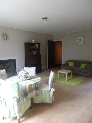 a living room with a table and a couch at Château de Nettancourt in Nettancourt