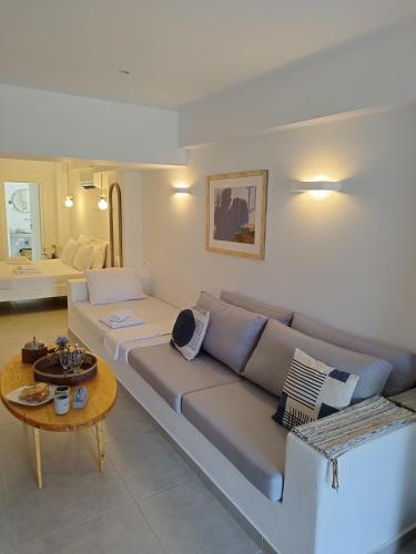 a living room with a couch and a table at Korina's Suites in Andros