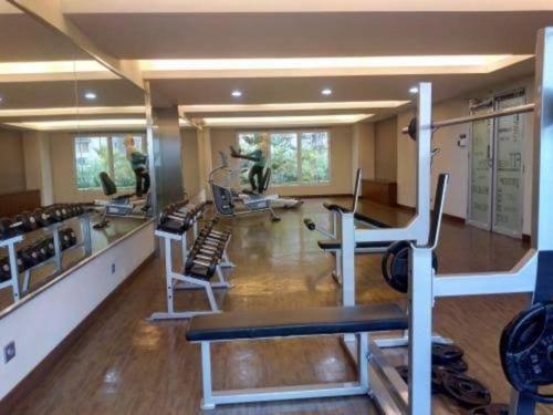 a gym with treadmills and chairs in a room at 2 BR The Oak Tower Apartment 9th Floor in Jakarta