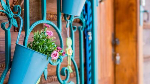 a blue potted plant hanging on a fence at Penzión Malý Majer Podlesok in Hrabušice