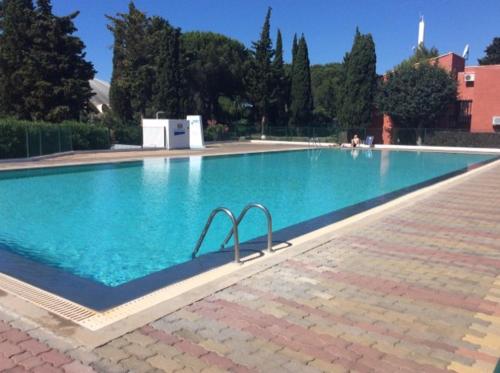 a large swimming pool with blue water at 5046 Tennis Village plus 1405 in Cap d'Agde