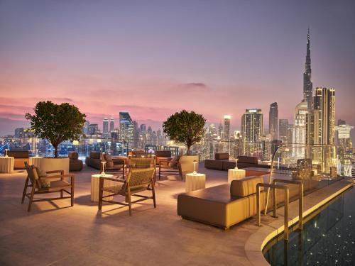 a rooftop lounge with a view of the city at The Lana - Dorchester Collection in Dubai