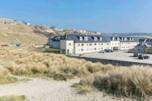 a large building on the side of a beach at Surf's Up in Perranporth, Cornwall Coastal Holidays in Perranporth