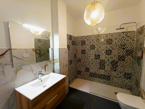 a bathroom with a sink and a shower at Milè in Bari