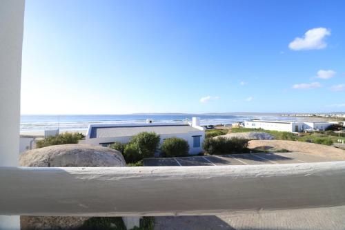 a view of the beach from the balcony of a house at Pikkewyntjie in Paternoster
