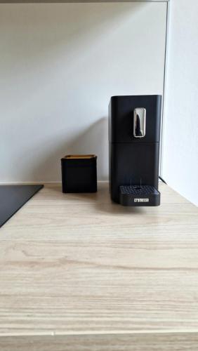 a black appliance sitting on top of a wooden floor at Central Apartment with a Magnificent View in Graz