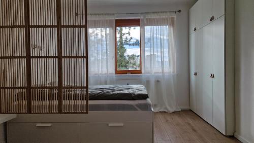 a bedroom with a bed and a window at Central Apartment with a Magnificent View in Graz