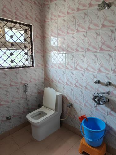 a bathroom with a white toilet and a window at Sunny Pines Resort in Lansdowne