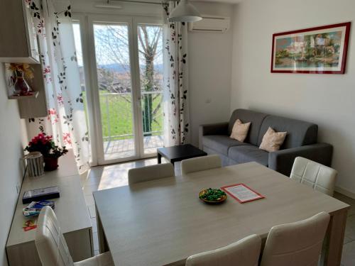 a living room with a table and a couch at Ennodio Apartment in Como