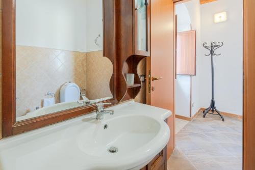 a bathroom with a white sink and a mirror at Casa Furore in Pachino