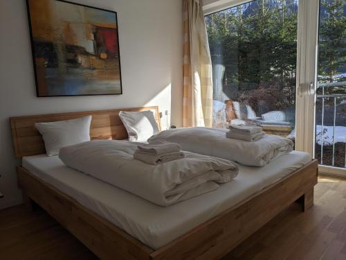 a bedroom with a bed with two towels on it at Chalet Schloßkopf FeWo Rendl in Sankt Anton am Arlberg