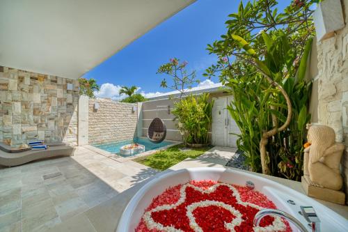 a table with a red cake on top of it at Bali Cosy Villas Seminyak in Legian