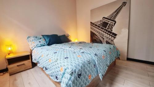 ein Schlafzimmer mit einem Bett und einem Bild des Eiffelturms in der Unterkunft Lokum z ogrodem in Płock