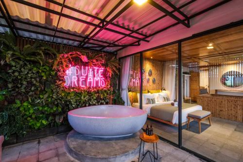 a hotel room with a bath tub and a bed at The Elementum in Uluwatu