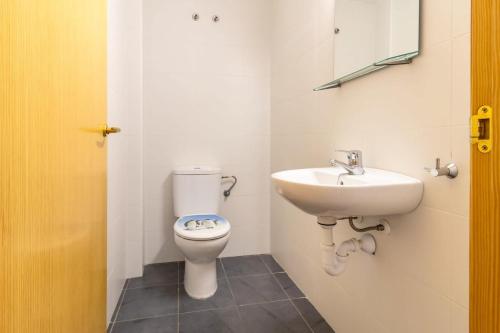 een badkamer met een toilet en een wastafel bij Cau del Llop 691 Apto con piscina comunitario in Llança
