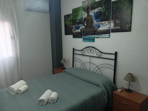 a bedroom with a bed with two pillows on it at Casa de Oro in Toledo