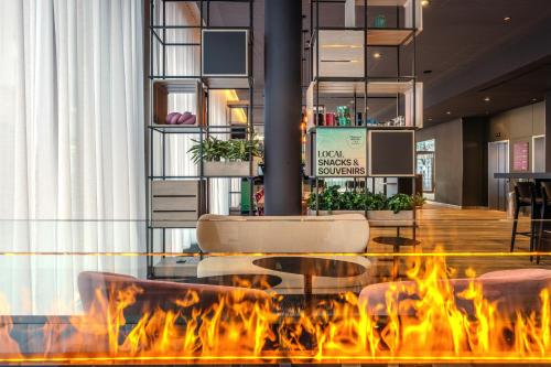 a fire pit in the lobby of a hotel at IntercityHotel Lübeck in Lübeck