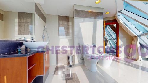 a bathroom with two toilets and a sink at Chestertons Go - Park Towers - DIFC in Dubai