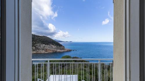 a view of the ocean from a balcony at VILLA MERAVIGLIA 8, Emma Villas in Nisporto