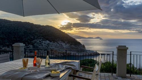 a table with a view of the ocean with an umbrella at VILLA MERAVIGLIA 8, Emma Villas in Nisporto