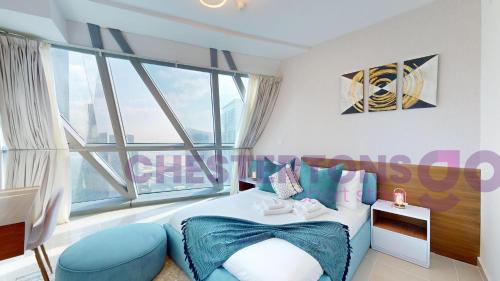 a bedroom with a bed and a large window at Chestertons Go - Park Towers - DIFC in Dubai