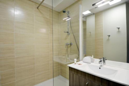 a bathroom with a sink and a shower at Résidence Odalys Côté Canal in Sallèles-dʼAude