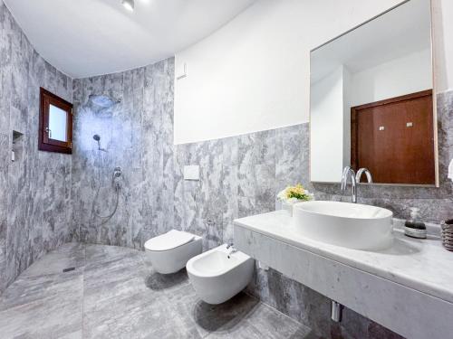 a bathroom with two sinks and a mirror at Villa Mizar - Newly Renovated Private and an Amazing View in Torre delle Stelle