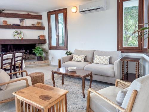a living room with a couch and a table at Villa Mizar - Newly Renovated Private and an Amazing View in Torre delle Stelle