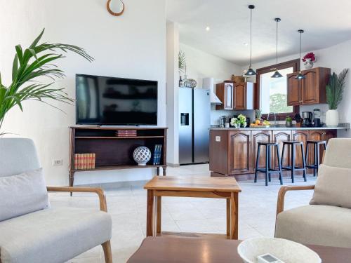 a living room with a tv and a kitchen at Villa Mizar - Newly Renovated Private and an Amazing View in Torre delle Stelle