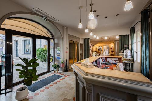 a kitchen with a island in the middle of a room at Logis Hostellerie des Clos et restaurant Bistrot des grands crus in Chablis