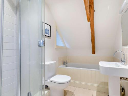 a bathroom with a toilet and a sink and a tub at 2 Bed in Cirencester 93878 in Coates