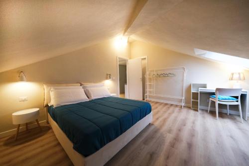 a bedroom with a large bed and a desk at La Mansardina di Rapallo by PortofinoVacanze in Rapallo