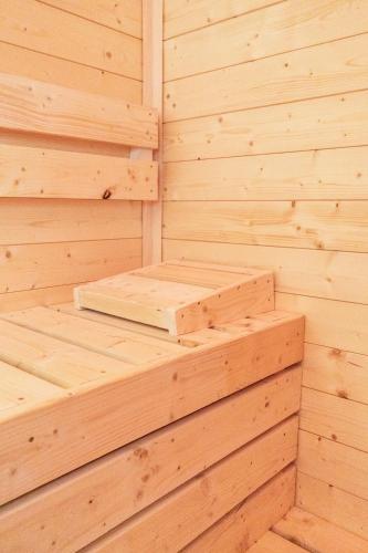 a wooden sauna with two wooden steps in it at Transylvania House in Arieşeni