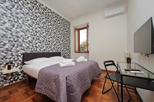 a bedroom with a bed and a table and a desk at 4BNB - Donatello Apartment in Rome