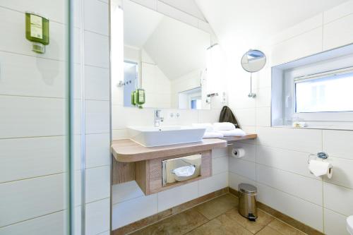 a bathroom with a sink and a mirror at Landhotel Burg im Spreewald - Resort & Spa in Burg