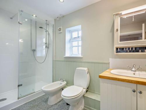 a bathroom with a toilet and a sink and a shower at 2 Bed in Mickleton 93980 in Mickleton